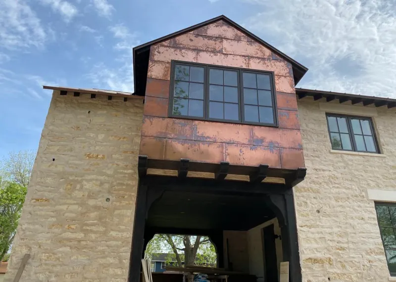 Copper metal panel facade on a stone building for Skylight Installation in Orange City