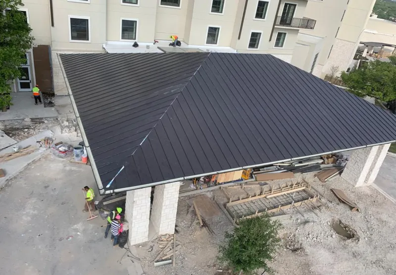 Metal roofing installation team working on a commercial building in Orange City