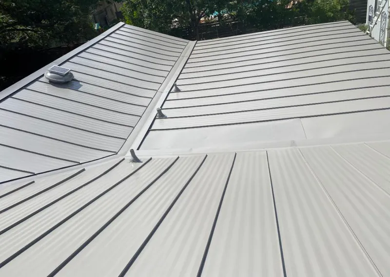 Solar attic fan installed on a metal roof for Roof Ventilation in Orange City